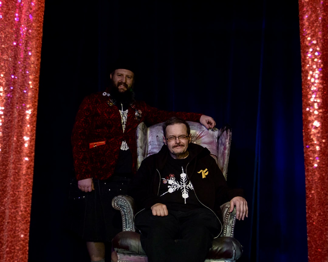 Harvey sitting with another festival volunteer
